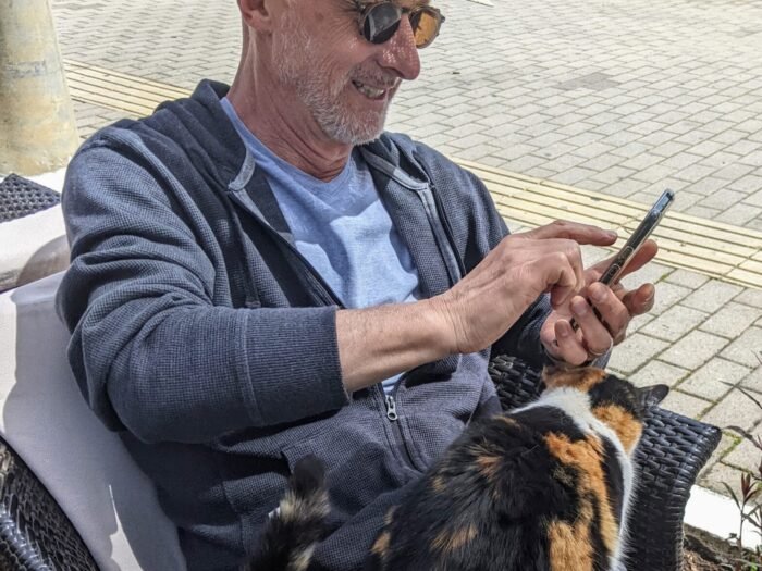 Patrick Baker with cat and smartphone