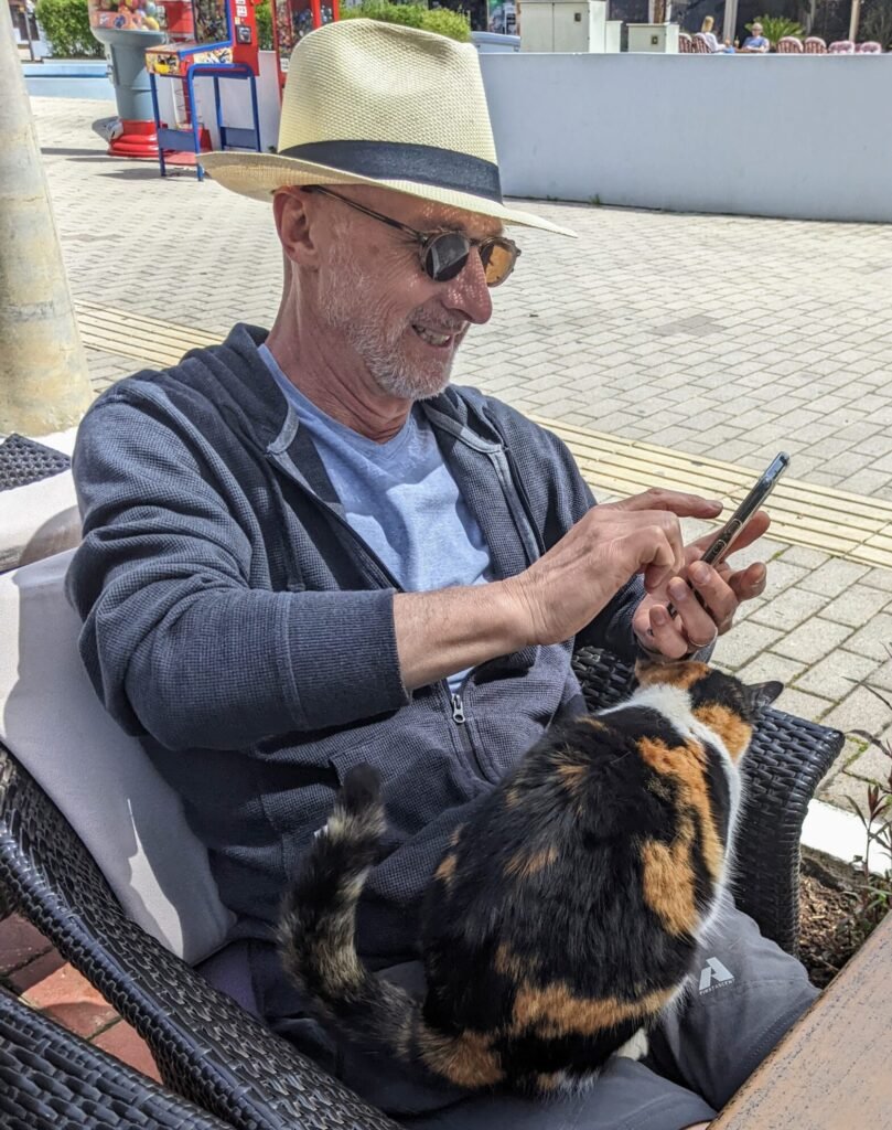 Patrick Baker with cat and smartphone