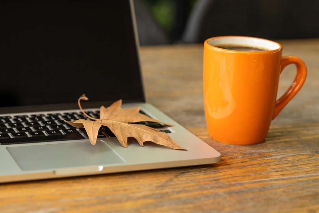 computer with coffee cup and maple leaf