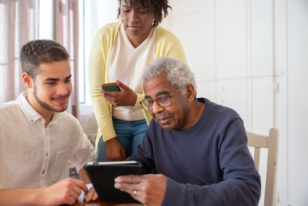 three people looking at a tablet