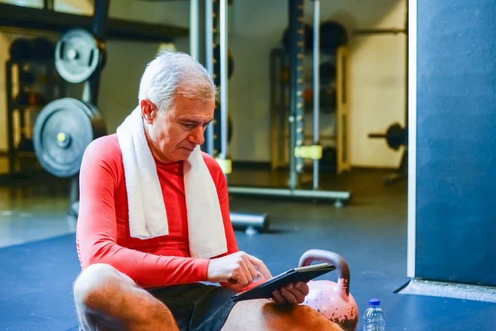 Man checking tablet during workout.