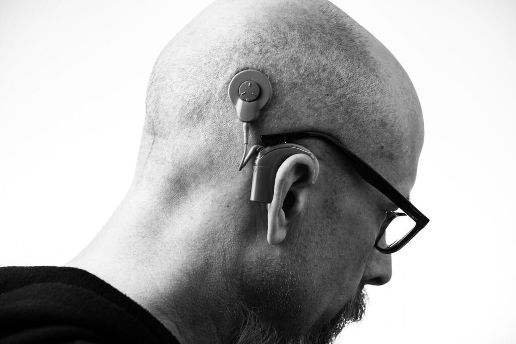 A person with a cochlear implant.