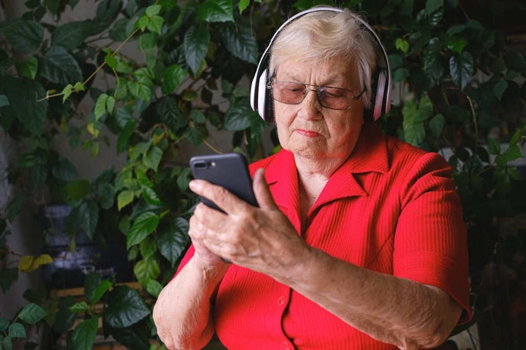 woman wearing headphones and looking at phone